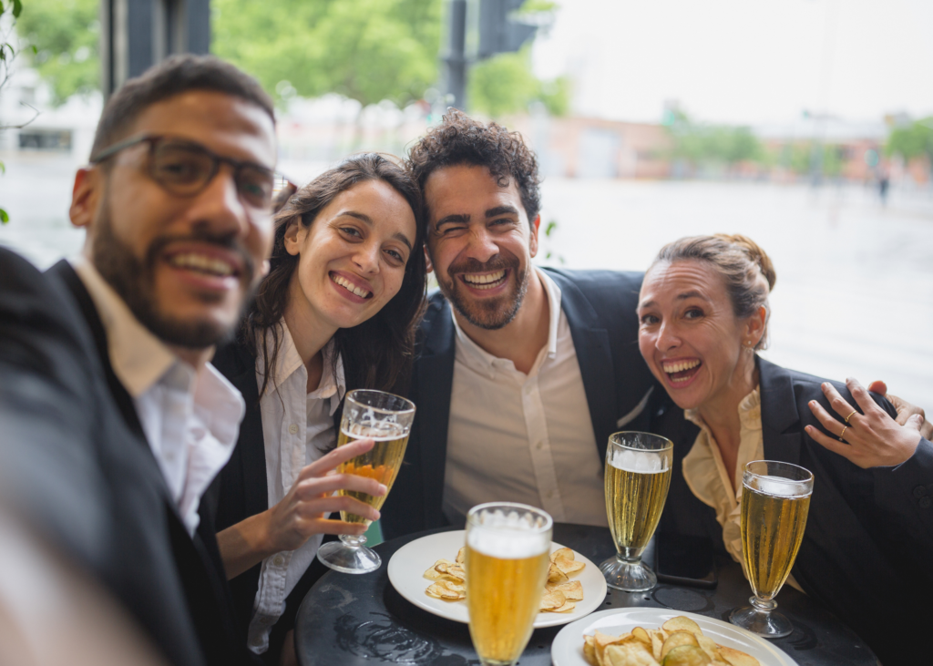 alcohol culture colleagues taking a selfie with beer 