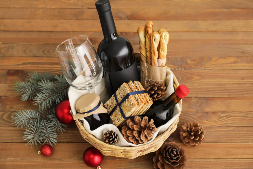 Corporate alcohol gift basket on office desk demonstrating gift etiquette for client appreciation